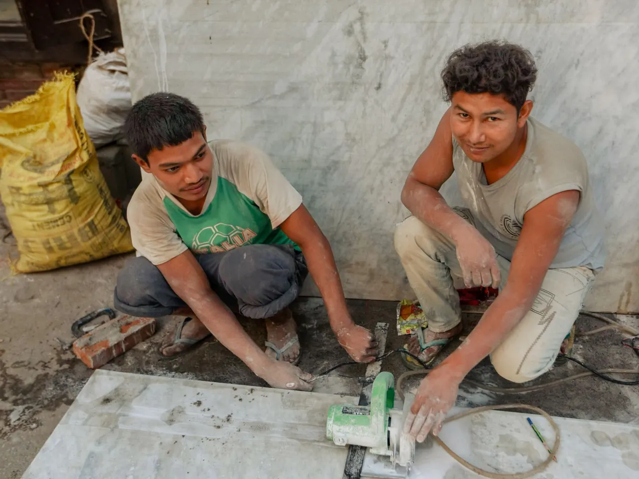 Two tradesmen at work, smiling